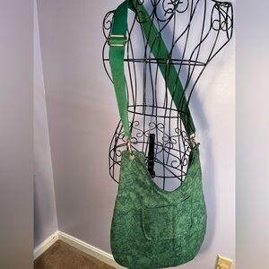 Women’s Handmade Green Shoulder Bag includes “Greenlight” home care items.